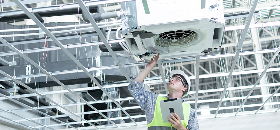worker inspecting industrial HVAC